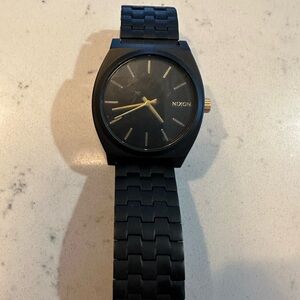 Nixon Black and Gold Timepiece